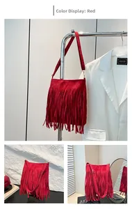 Detail view of the red fringe shoulder bag showing tassel texture and suede finish