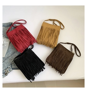 Flat lay of large capacity fringe crossbody bags in four retro colors for women