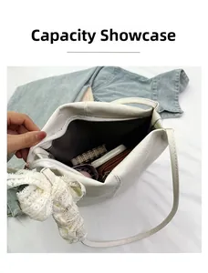 Capacity display of white leather bucket bag with lace floral charm and interior items
