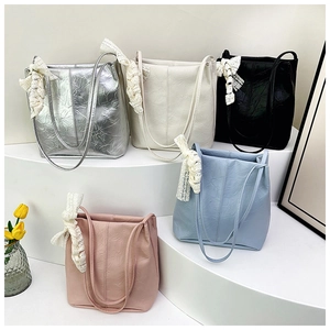 Detailed collection of colorful pleated tote bags with elegant lace ribbons on handles