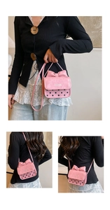 Detail of pink bow handbag with black polka dots and detachable leather shoulder strap