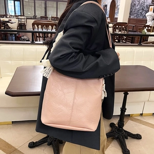 Chic pink oversized faux leather tote bag with pleated texture for stylish commuting