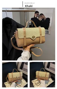 Detail of khaki square handbag with woven texture, metal lock, and adjustable strap