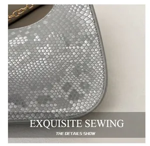 Close-up of silver snake embossed leather texture and fine stitching on a handbag