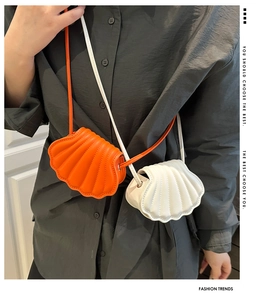 Close-up of shell-shaped crossbody bags in orange and white with quilted faux leather texture