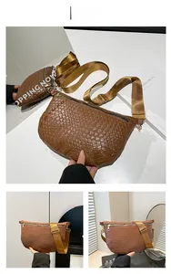 Detail view of brown woven crossbody bag featuring adjustable wide strap and texture