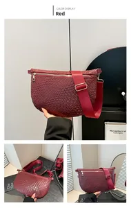 Detailed close-up of wine red woven leather crossbody bag with wide nylon strap