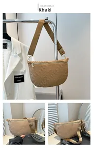 Detail of khaki moon bag showing intricate woven texture and wide adjustable strap