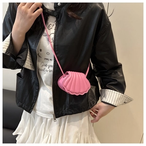 Close-up of pink shell-shaped crossbody bag with elegant stitched texture and chain strap