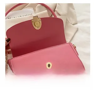 Detail shot of the magnetic snap closure on the pink retro small square shoulder bag