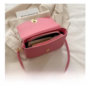 Interior capacity of the pink flap bag showing a smartphone and wallet storage
