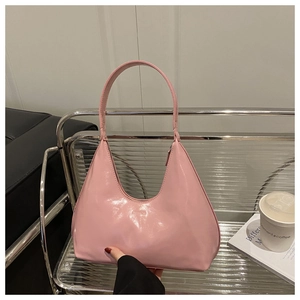 Detail of pink hobo shoulder bag in glossy patent leather finish for spring