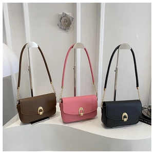 Minimalist crossbody bags with golden horseshoe buckles in brown, pink, and black