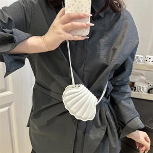 Chic white shell-shaped crossbody bag with pleated texture and thin shoulder strap