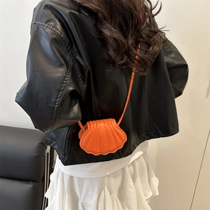 Chic orange shell-shaped mini crossbody bag with textured design for trendy women