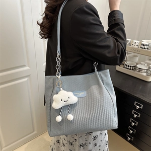 Trendy light blue tote bag with silver chain strap and cute cloud charm accessory