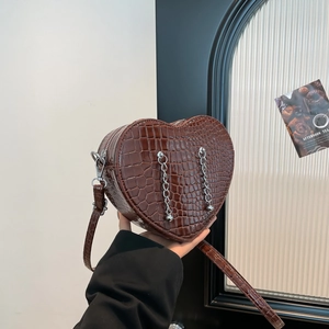 Minimalist heart-shaped crossbody bag in dark brown croc-embossed leather with silver chains