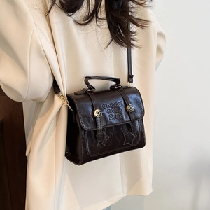 Retro dark brown crossbody satchel with star patches and embossed letter detailing