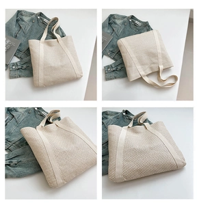 Close-up of large capacity cream-colored woven straw tote bag with wide fabric handles