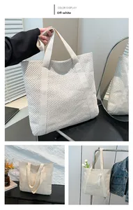 Detail view of off-white woven tote bag with geometric texture and dual strap design