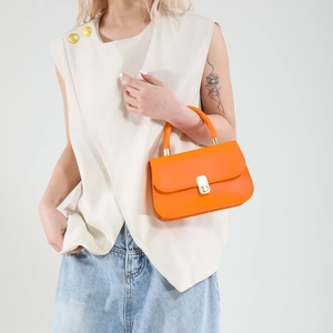 Vibrant orange leather handbag for women featuring a gold twist lock and top handle