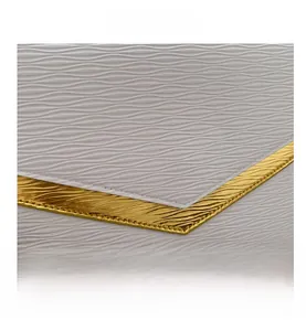 Detail of cream envelope clutch with wavy texture and gold V-shaped metal hardware