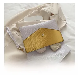 Detail view of large envelope clutch bag showing spacious interior with makeup items