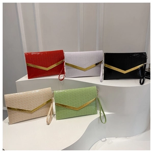 Detail of envelope clutch bags with gold V-trim metal accents and striped texture