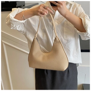 Close-up of beige woven hobo bag with silver zipper and minimalist knit texture