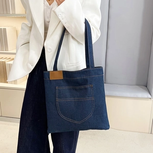 Large denim tote bag in dark blue with front pocket for casual autumn daily wear