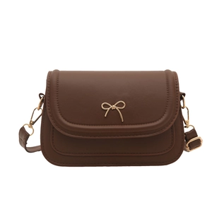 Chic dark brown crossbody bag with gold bow clasp and adjustable leather shoulder strap