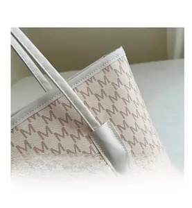 Close-up of the tote bag showing the M letter print and precise white stitching detail