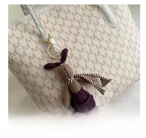 Cute brown knitted bunny charm with striped scarf on large tote bag detail