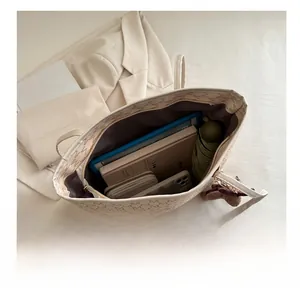 Large capacity tote bag interior showing space for tablet, notebook, wallet, and umbrella