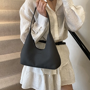 Retro black hobo shoulder bag with woven texture for women shown in lifestyle outfit