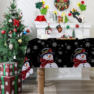Detailed view of snowman and snowflake prints on a festive polyester Christmas tablecloth