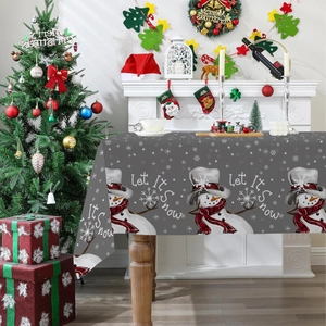Detail of grey Christmas tablecloth featuring snowman print and Let It Snow text