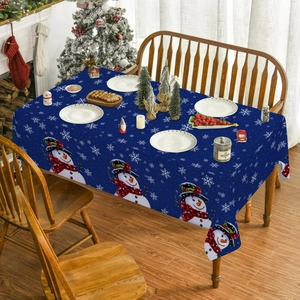 Close-up of Christmas snowman print on navy blue polyester tablecloth in cozy home setting