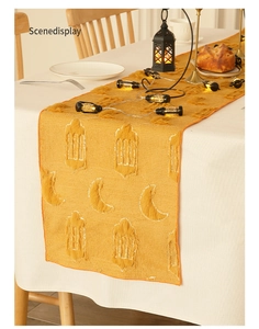 Close-up of golden moon embroidery on velvet table runner for Ramadan festive decor