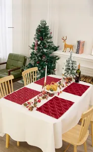 Close-up of burgundy PV velvet placemats with gold embroidered Christmas tree patterns