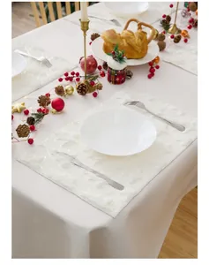 Macro detail of white PV velvet placemat with 3D embroidery and festive Christmas texture