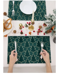 Close-up of green plush Christmas placemat with gold sequin embroidered trees