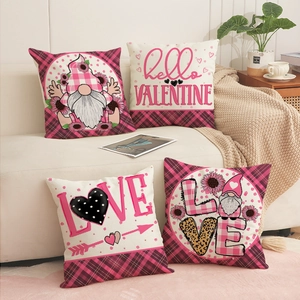 Set of four Valentine's Day pillow covers with gnome prints on a white home sofa
