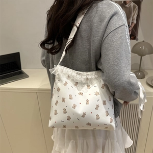 White shoulder bag with cute koala print and lace trim decoration on model back