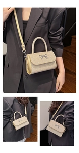 Macro detail of champagne gold glitter crossbody bag with silver bow accent