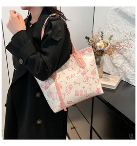 Detail of white tote bag with pink graffiti bear patterns and sturdy shoulder straps
