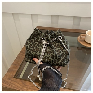Detail of leopard print bucket bag with silver chain and white pearl accents