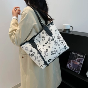 Contrast graffiti tote bag with cartoon print and black handles for summer 2025 fashion