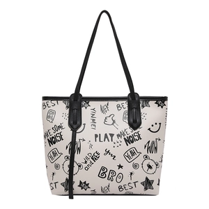 Minimalist cream tote bag with black graffiti print and large capacity for commuting