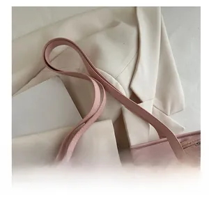 Detail of pink faux leather tote with bear pattern and black diamond print